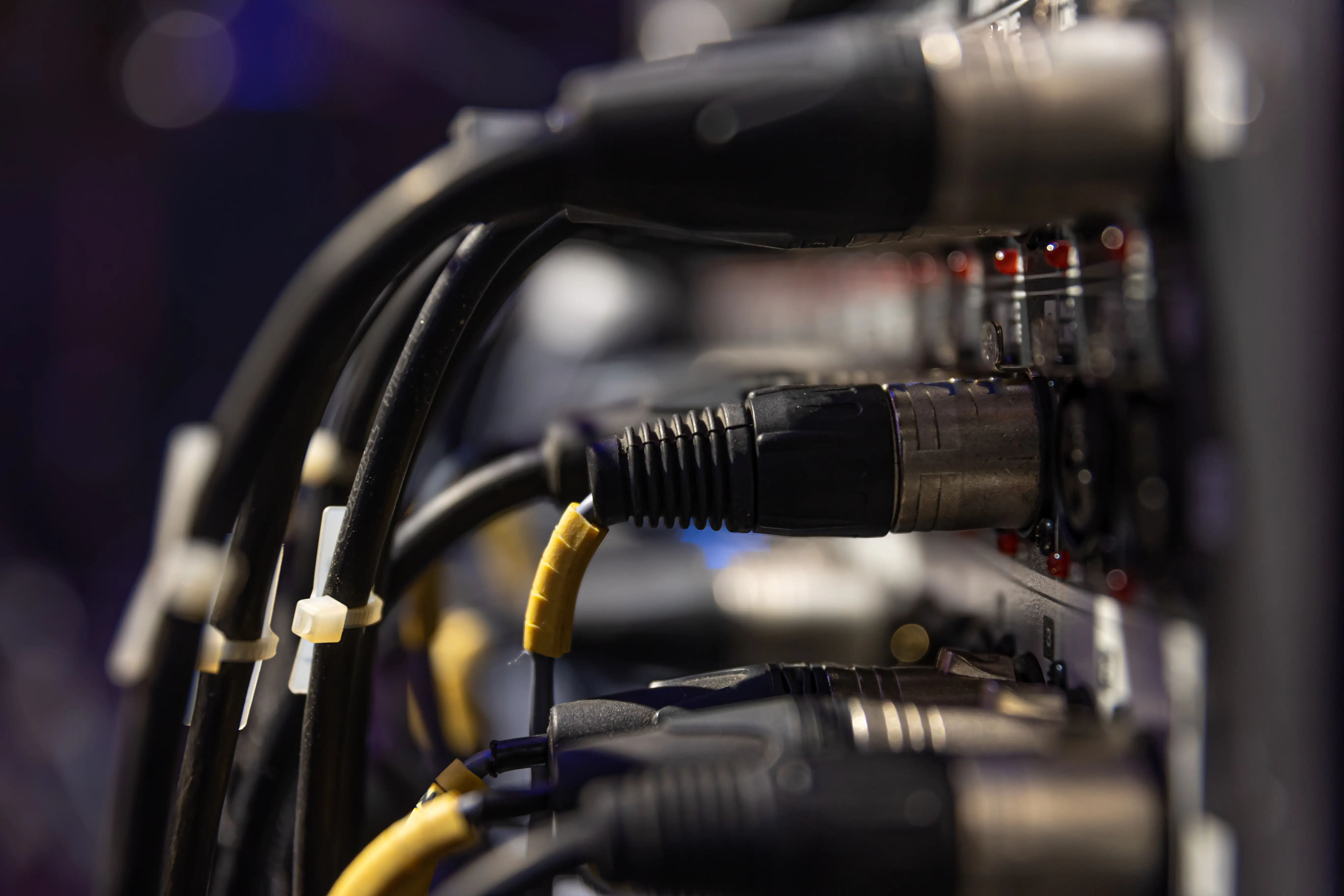 Cables and connectors plugged into rack-mounted equipment